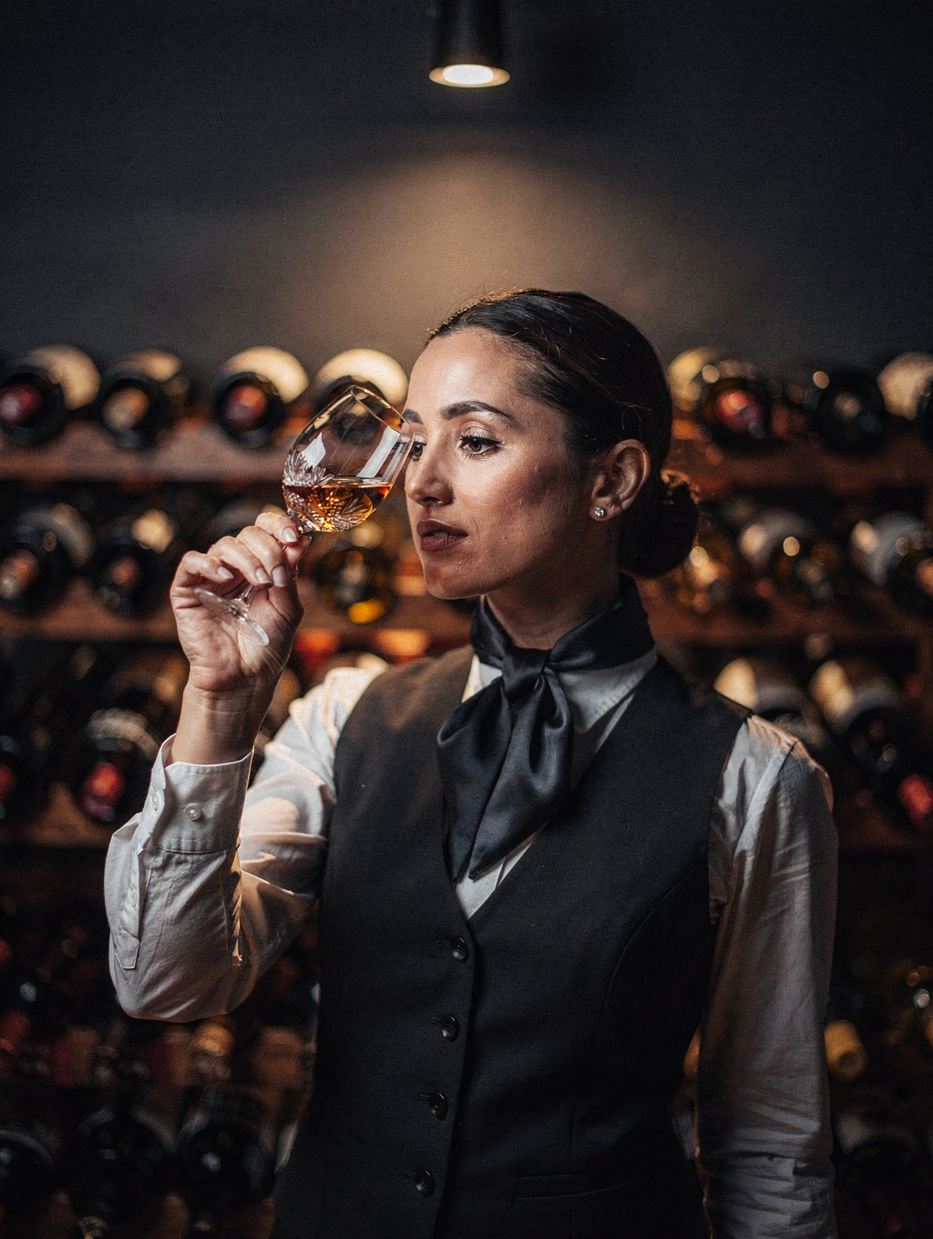 Sofia Romano evaluating a glass of Italian vintage wine